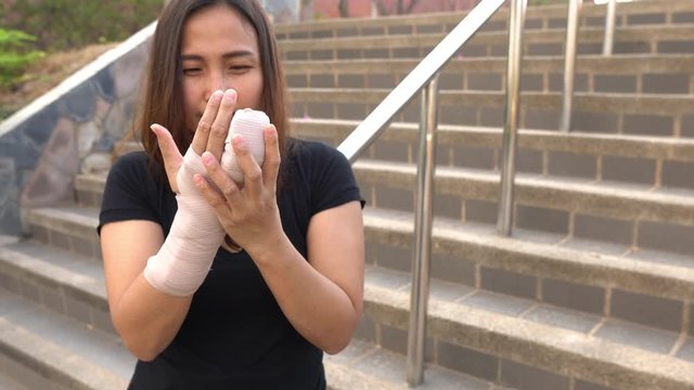 A beautiful Asian girl broke her arm and splinted,Woman accidentally falls, arms hit the ground, causing fractures,	