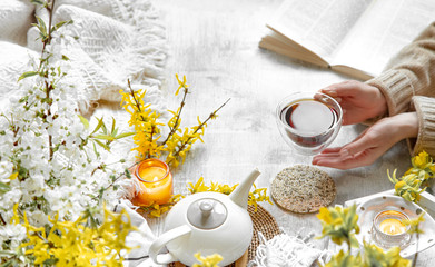 Spring still life with a Cup of tea and flowers .