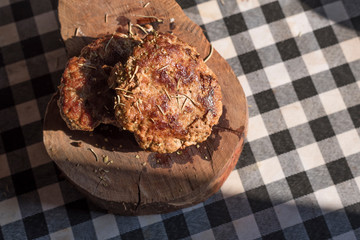Steak beef hamburg on chopping board on grid pattern table