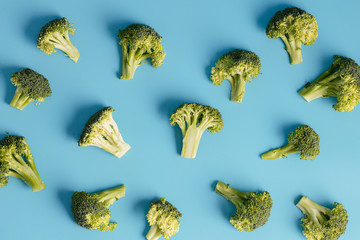Broccoli on blue background. Pieces of broccoli. Top view. Healthy food.