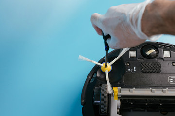 A man is fixing a wireless vacuum cleaner. Smart cleaning technology isolated. Top view.