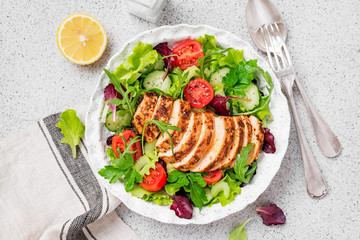 Grilled chicken breast, fillet and fresh vegetable salad. Healthy lunch menu.