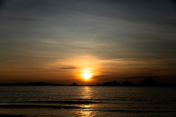 Naklejka na ściany i meble Beautiful sunset on the beach with islands
