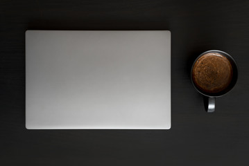 workplace composition with laptop and coffee