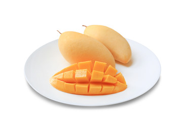 Delicious golden mango fruit in white plate isolated on white background. Ripe yellow Barracuda mangos. Tropical fruit in thailand.