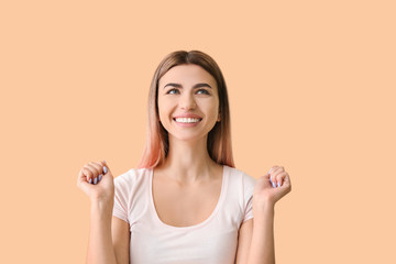 Happy woman with healthy teeth on color background