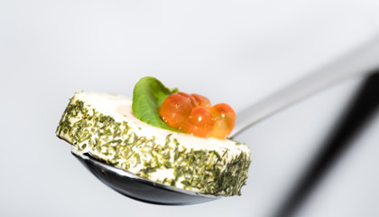 Tasty canapes plates in line hanging with caviar and cream