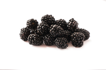 Blackberries isolated on white background. Blackberries with copy space for text. Ripe blackberry close-up. Background berry. Sweet and juicy berry. Heap of blackberries on white background.Black food