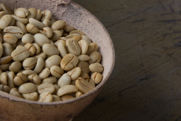 White coffee beans on old rusty background