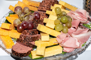 Selection of fresh cuts antipasto: ham, cheese,