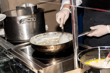 Chef preparing pasta during brunch buffet or food bloggers