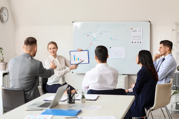 Businesswoman giving presentation in office