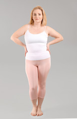 Overweight woman on grey background