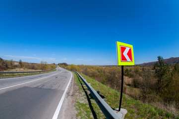 highways in the mountains against the background of the sunny sky and the white clouds