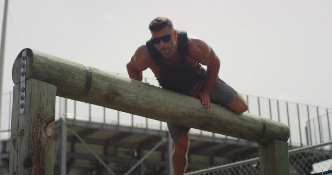 Athletic man performing obstacle course training