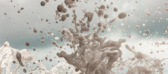 The waves breaking on a stony beach, forming a spray © Iryna
