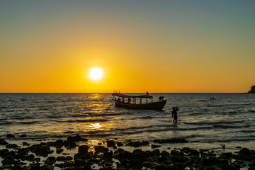 Fototapeta na wymiar A boat in the sea with the sunset background at Koh Ta Kiev, Cambodia