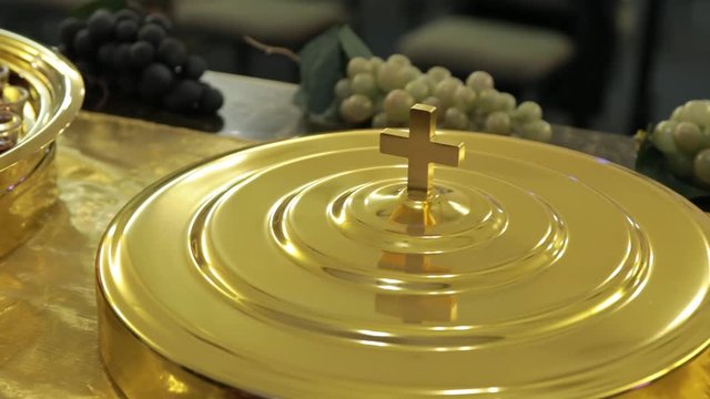 Christian religious Holy Communion, closeup of golden cross on box 