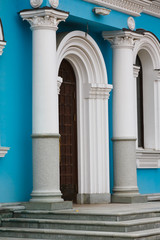 portal, entrance to the Church, blue wall, white columns and granite staircase
