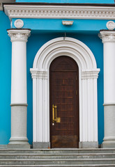 portal, entrance to the Church, blue wall, white columns and granite staircase