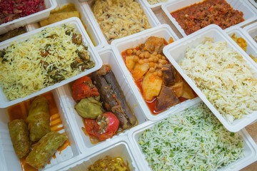 Delivery sets of healthy and delicious food in boxes . A variety of fast food in plastic boxes .