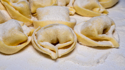 Delicious tortellini a ring-shaped pasta from Italy. Traditionally they are stuffed with a mix of meat, parmigiano reggiano cheese, egg and nutmeg