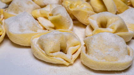 Delicious tortellini a ring-shaped pasta from Italy. Traditionally they are stuffed with a mix of meat, parmigiano reggiano cheese, egg and nutmeg