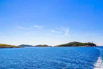 Panoramic view of croatian islands in the sea with lighthouse on Vela Sestrica near Kornati, Adriatic Sea, Croatia. Vacation travel concept.