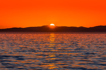 Background with landscape of sunset over sea, scenic view from beach in Zadar, Dalmatia, Croatia