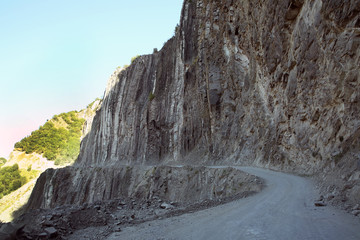 Fototapeta na wymiar Mountainous road leading to Lahic village in Ismayilli region of Azerbaijan, with car.