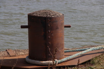 Steel bollards on the quay of the port of Rotterdam where ships moor and attach themselves with...