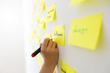 Business people write notes on post paper stickers. Meeting and brainstorming team.