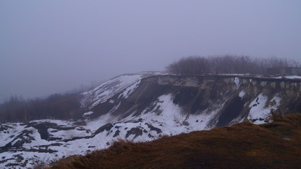 winter landscape with cliff in the fog