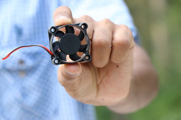 Fototapeta premium Mini CPU Cooler held in hand 