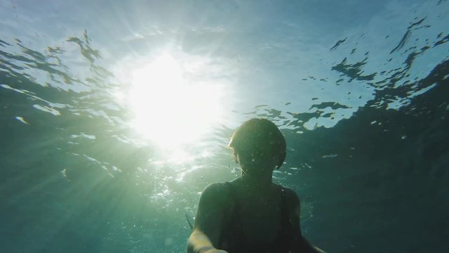Freediver on corals in Red sea, Beautiful young woman swimming underwater in blue sea water, Dahab Egypt, 4k