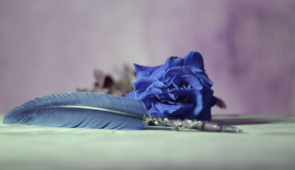 a rose and a blue pen