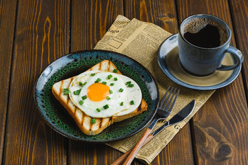 fried eggs on toast with hot coffee
