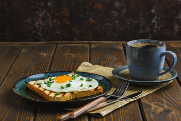 fried eggs on toast with hot coffee