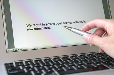 Letter of termination of employment or service. Words typed on the computer screen.