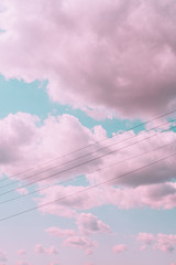 Aesthetic beautiful turquoise sky with pink clouds and wires or cables. Angel paradise concept