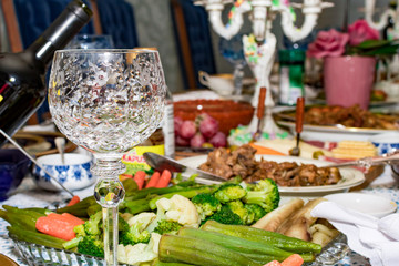 Closeup shot of a wine glass with blurry dinner background