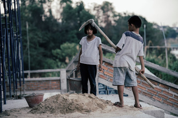 Children are forced to work in the construction area. Human rights concepts, stopping child abuse, violence, fear of child labor and human trafficking