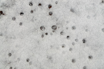 background with snow and holes made by droplets