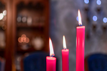 Closeup of a red burning candles. three red candles burning