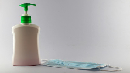 Liquid soap to protect hands against viruses, white bottles, green pumps, white background, coronaviruses, Covid-19