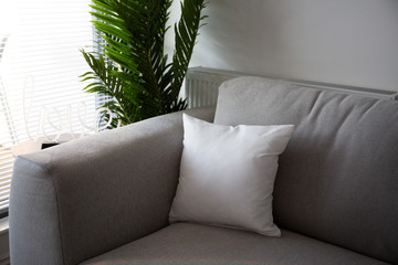 Grey pillow on grey sofa