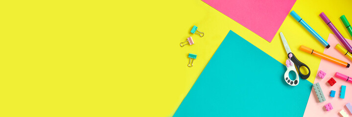 School supplies, stationery on yellow background - space for caption. Child ready to draw with pencils and make application of colored paper. Top view.