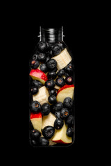 Bottle with slices of fruits for smoothie on black backgraund-2