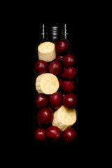 Bottle with slices of fruits for smoothie on black backgraund top view-7