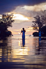 Fototapeta premium Traditional fire show at sunset in Thailand